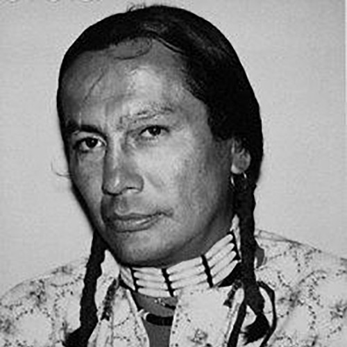 Black and white portrait of Russell Means. This photograph was used by Andy Warhol for his silkscreen The American Indian (Russell Means), 1976.