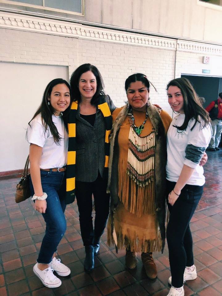 Color photograph showing the three female student leaders of the American Indian Students Association posing with William & Mary president Katherine Rowe.
