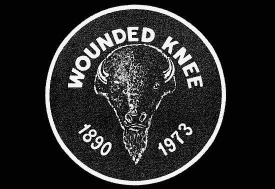 Round black and white logo of a buffalo head with the text ”Wounded Knee” written above the head and the dates 1890 and 1973 written below.