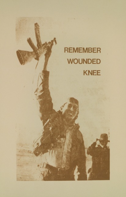 Poster with the text ”Remember Wounded Knee” over a large image of Robert Onco holding a rifle above his head at the Wounded Knee occupation.